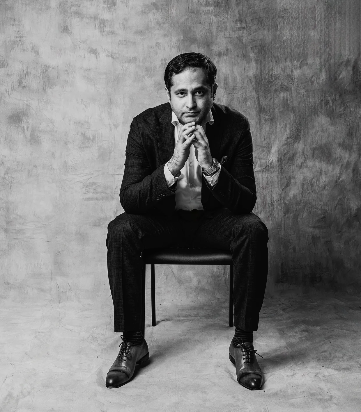 Zahaib Nabeel, seated black-and-white studio portrait
